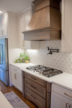 a stove top oven sitting inside of a kitchen