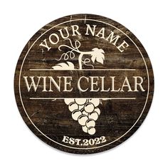 a wooden wine cellar sign with the words your name and some grapes on it's side