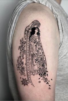 a woman with a veil and flowers tattoo on her arm