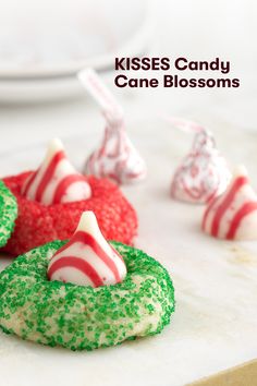 candy cane blossoms on a table with other candies in the background and text overlay that reads kisses candy cane blossoms