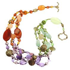 The Prehnite Amethyst Carnelian Necklace adds an artistic touch to your jewelry collection. Its vibrant strands of color instantly brighten solid tops and dresses or add a pop of interest when layered. Handmade in the USA, the necklace features a mix of smooth and faceted amethyst, carnelian and prehnite gemstone beads. Complementary purple, orange and green hues create a lively tropical look. Prehnite Amethyst Carnelian Necklace - Vibrant Gemstone Strands Brighten Any Outfit Add an instant pop Carnelian Necklace, Artisan Bracelets, Night Looks, Handmade Necklace, Multi Strand, Gemstone Necklace, Handmade Necklaces, Gemstone Beads, Gemstone Jewelry