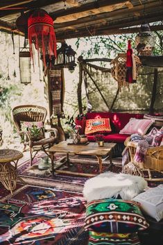 a living room filled with lots of furniture and rugs on top of a floor