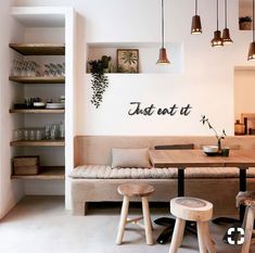 a living room filled with furniture and lots of lights hanging from the ceiling next to bookshelves