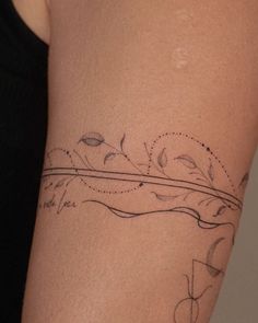 a woman's arm with a tattoo design on the left side of her body