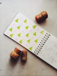 two corks are laying on top of a notepad