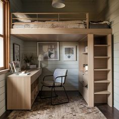 there is a loft bed and desk in this small room with stairs to the second floor