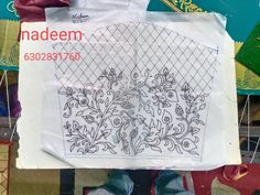 a person standing next to a bag with some designs on it and the words naddeen printed on it