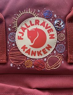 a red backpack with an embroidered sticker on the front that says, falfraven kankenn