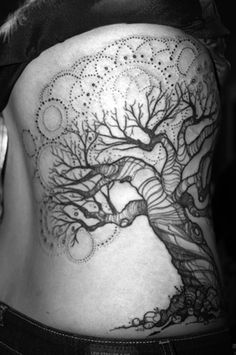 a woman with a tree tattoo on her back