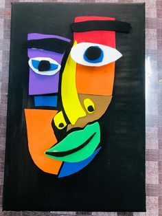 a piece of art that looks like a man's face with different colors and shapes