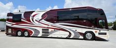 a red and white bus parked in a parking lot