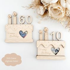 two wooden birthday cards with hearts and candles on them, next to a bouquet of flowers