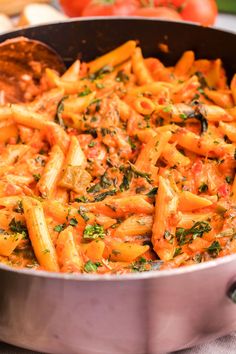 a pot filled with pasta and vegetables on top of a table