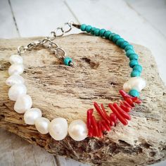 This elegant Summer Bracelet for Women, Boho and Hippie Style, is handmade with love from Greece. This fashionable piece of art combines turquoise howlite stones, red coral chips and white freshwater pearls, all knotted with a tiger tail cord. It's adjustable, in order to fit any wrist size and wearable either on its own, or layered with your other bracelets. This ultimate trendy summer accessory can be a beautiful gift for a beloved friend, or a gift to spoil yourself! Make it yours and add a t Handmade Coral Bracelet With Round Beads, Handmade Turquoise Pearl Bracelet For Beach, Turquoise Beaded Bracelets With Lobster Clasp As Gift, Turquoise Beaded Bracelet With Lobster Clasp As Gift, Handmade Ocean-inspired Round Beaded Bracelet, Ocean-inspired Bracelets With Colorful Beads For Gifts, Ocean-inspired Bracelets With Colorful Beads As Gifts, Ocean-inspired Beaded Bracelets For Gifts, Ocean-inspired Beaded Bracelets As Gifts