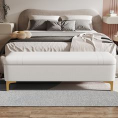 a white bed sitting on top of a wooden floor