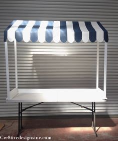 a white and blue awning on top of a table