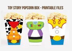 three boxes filled with popcorn sitting on top of a white table next to the words toy story popcorn box - printable files