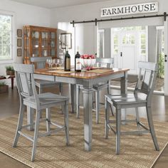 a dining room table with chairs and a wine rack