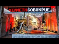 a display window with star wars action figures in the front and behind it is a sign that says kennet cobonpue