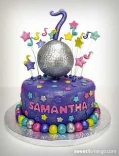 a birthday cake decorated with stars and an acrobatic number one on top