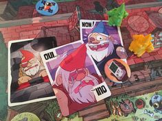 the game board has pictures of gnomes and other things on it, including cards