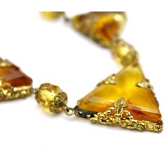 Fab Antique 1920s Art Deco Necklace and earrings, otherwise known as a demi-parure. The set consists of a gorgeous and superbly designed necklace, 16" long, with an amber glass chain with some brass filigree spacers. Then there are the three triangles of yellow amber faceted glass, each framed with amazing filigree.It is so 1920s, utterly Art Deco.The earrings are square cut glass with screw backs. While they came with the necklace I'm not sure they were originally a set. But wearing it together 1920s Art, Art Deco Necklace, 1920s Art Deco, Vintage Fits, 1920s Fashion, Faceted Glass, Necklace And Earrings, Amber Glass, Cut Glass