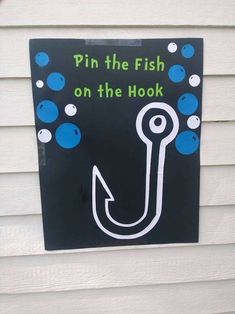 a sign on the side of a house that says pin the fish on the hook