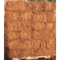 a pile of hay sitting on top of a wooden pallet