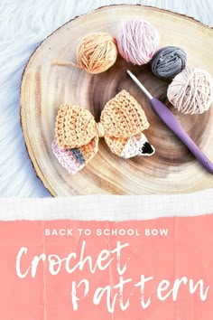 the back to school bow crochet pattern is on a wooden plate with yarn