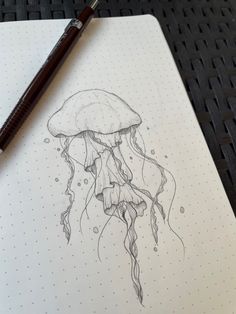 a drawing of a jellyfish on a notepad