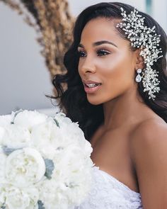 a beautiful woman holding a bouquet of white flowers