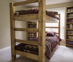 a bedroom with bunk beds and bookshelves in it