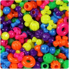 a pile of colorful plastic beads that look like letters and numbers for children to play with