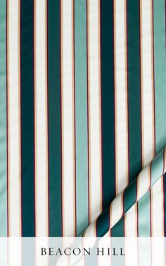 an image of a bed with green and white striped sheets