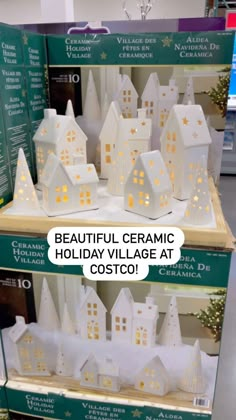 two boxes with white houses on them and the words beautiful ceramic holiday village at costco