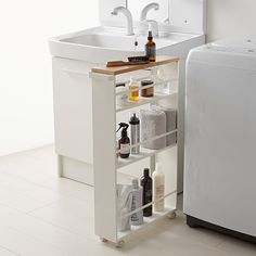 a white sink sitting next to a washer and dryer