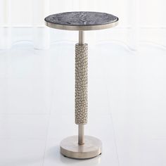 a round table with a marble top and metal base