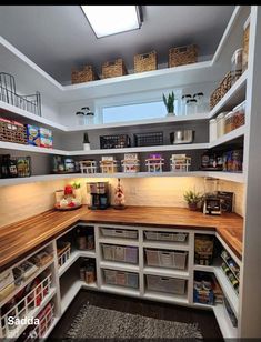 an organized pantry with lots of shelves and baskets on the top shelf, under a skylight