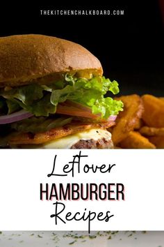 a hamburger with lettuce, tomato and onion on it next to some french fries