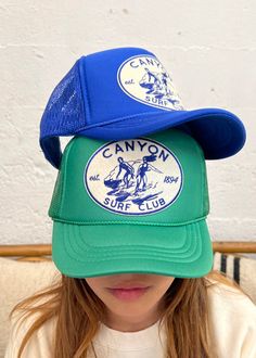 In an effort to reduce and repurpose, we designed our Canyon Surf patch with the intention to rescue our purple corduroy truckers from the fate of the landfills. After a misprint deemed these hats unusable for our client, we were able to create meaning from the mishap and our official Canyon Surf Club was born. Now also available in Green and Blue foam truckers as well as our newest Forest twill trucker. Adjustable sizing Unisex fit Cornell Merch, Sea Club, Surf Hat, Surf Club, Vintage Trucker Hats, Socks And Sandals, Cool Hats, Girl With Hat, Pickleball