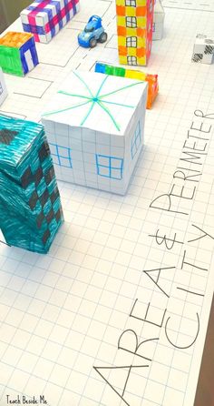 an art project is displayed on a sheet of paper with colored blocks in the shape of houses