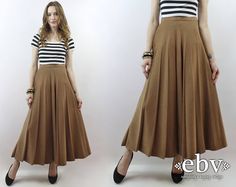 Vintage nineties HIGH WAISTED PLEATED MOCHA MAXI SKIRT. High waisted. Zips + buttons at left hip. Material is soft, feels almost like a microsuede. Model is 5'9. Her measurements are: bust=34 inches, waist=26 inches, & hips=34 inches. The skirt fits as shown on her. We measure on a flat surface from seam to seam. Bust, waist, & hip measurements have already been doubled. We suggest you compare our measurements to a garment you already own and know fits you well to ensure a proper fit. label: bonnie & norma approximate size: S vintage size on tag: 6 material: 70% viscose, 30% poly waist: 26 inches hips: 40 inches length: 38.25 inches VERY IMPORTANT WE DO NOT TAKE RETURNS FOR ITEMS THAT DO NOT FIT. We take extreme care to measure each item accurately, so please take note of the measurements. Neutral Skirt, 90s Skirt, Petite Fashion Tips, Short Women Fashion, Brown Skirt, Skirt High Waist, Skirt Pleated, Pleated Maxi Skirt, High Waist Skirt