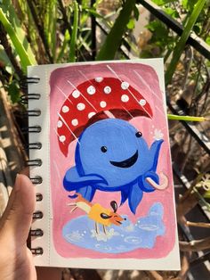 a drawing of a blue whale holding an umbrella over its head in front of some plants