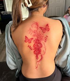 a woman with a red tattoo on her back