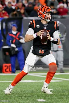 a football player holding a ball on the field