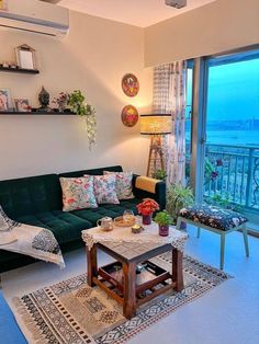 a living room filled with furniture and a large window