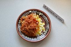 a plate with some food on it next to a sign that says, let's go macaroni and cheese