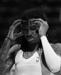 a man with dreadlocks holding his head