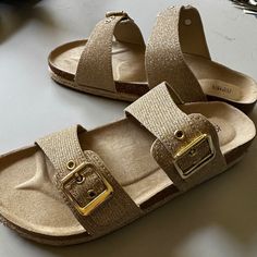 Tan, Gold Glitter Straps, Cork And Raffia Sole. New With Box, Never Worn, Just Tried On Indoors. Bought When Store Labeled Them As My Size, But They Are A 9. Straps Buckle And Are Adjustable Wider Or Narrower. Comfortable Gold Synthetic Sandals, Comfortable Gold Open Toe Sandals, Casual Gold Sandals With Textured Footbed, Gold Sandals With Cork-bed Midsoles, Spring Gold Footbed Sandals With Textured Footbed, Gold Textured Footbed Sandals For The Beach, Adjustable Glitter Casual Sandals, Casual Gold Footbed Sandals For Beach, Casual Adjustable Glitter Sandals