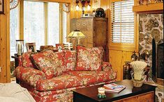 a living room filled with furniture and a fire place next to a wall mounted clock